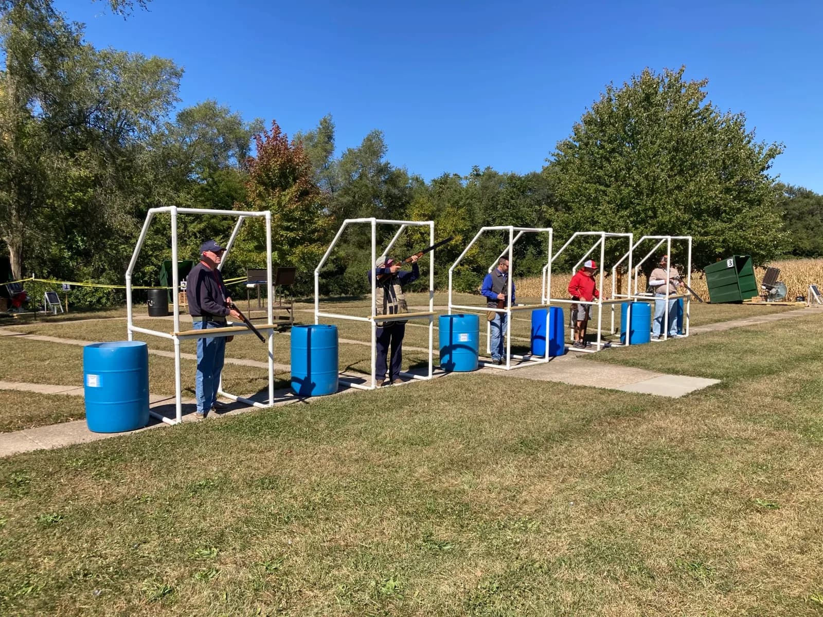 Shotgun shooter at clay target station during competition