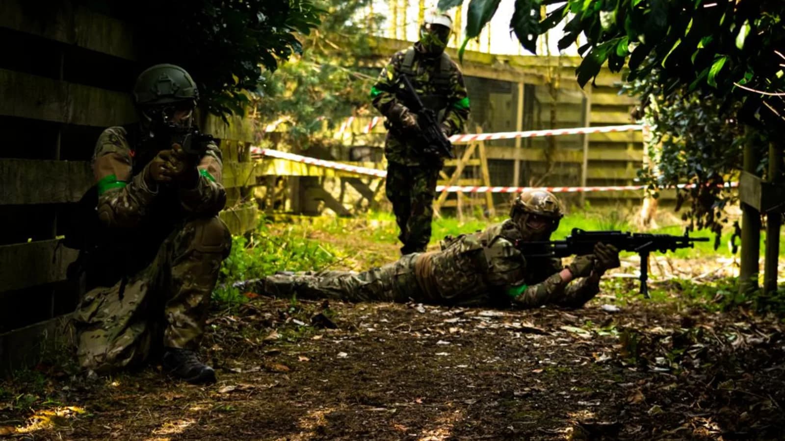 Airsoft squad in tactical gear during a milsim game