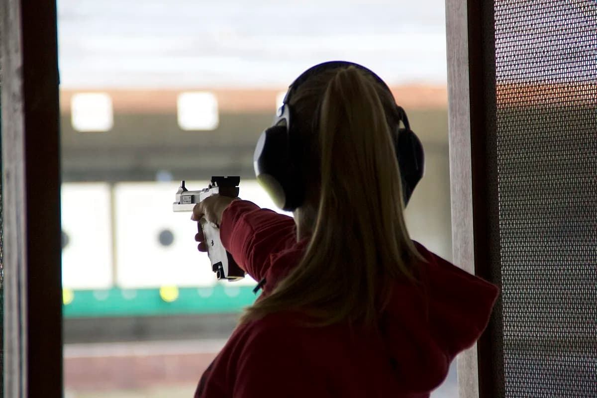 Female athlete fires an ISSF Sport Pistol during international competition