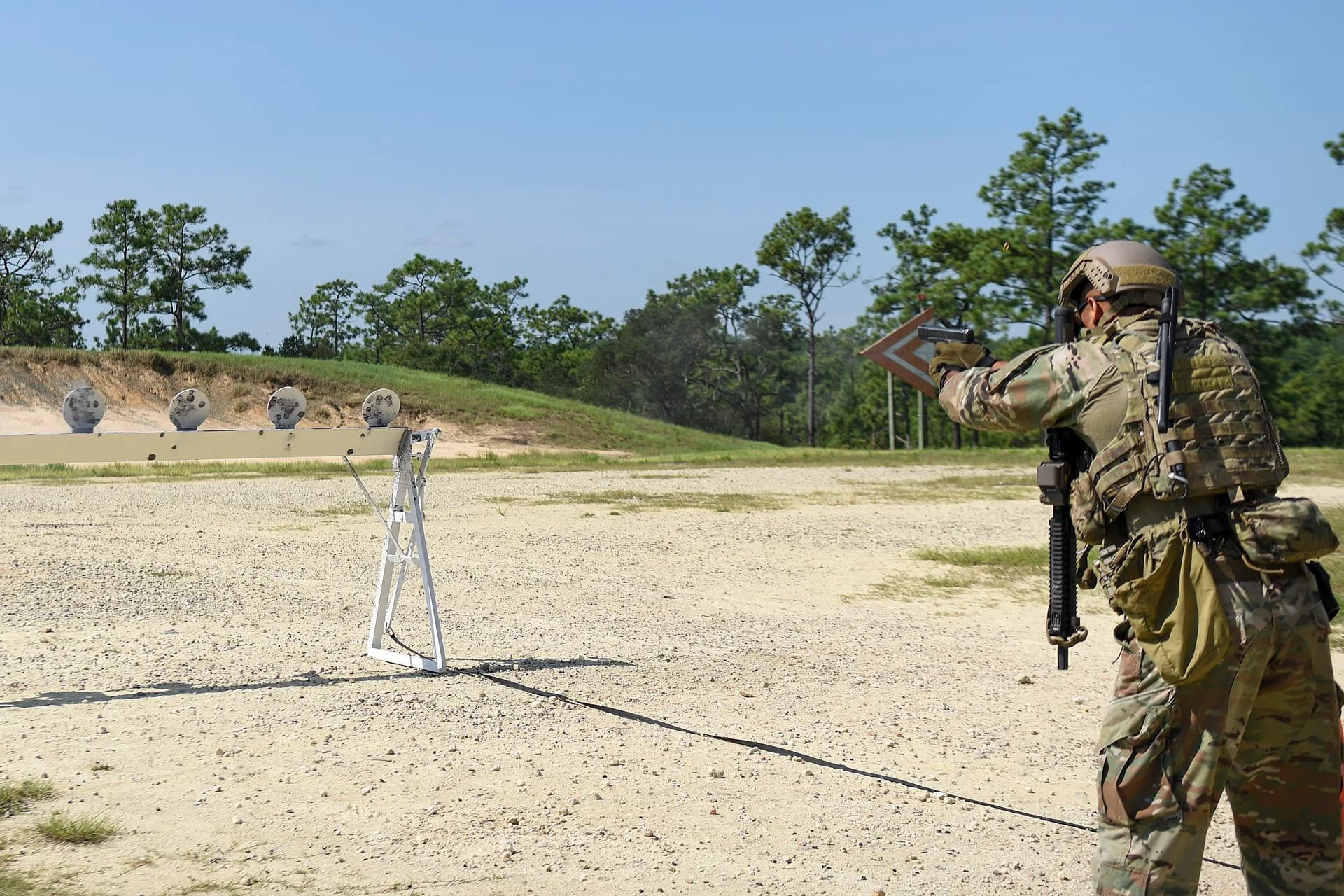Shooter engaging steel targets during speed shooting competition